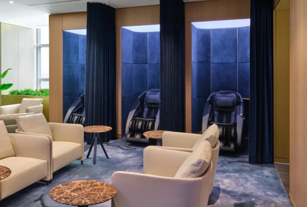 A modern wellness lounge with massage chairs in private alcoves
